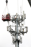 Technicians work on cell tower in Hamilton