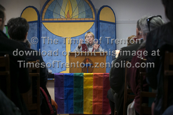 Church dedicates replacement for stolen gay pride flag