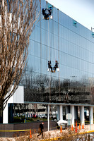 Window cleaners rappel down building